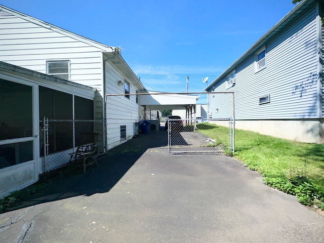 exterior space with a sunroom and a carport