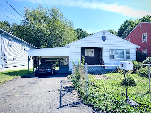 bungalow-style house featuring a carport and a front yard