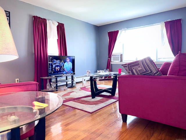 living room featuring cooling unit, wood-type flooring, and a baseboard heating unit