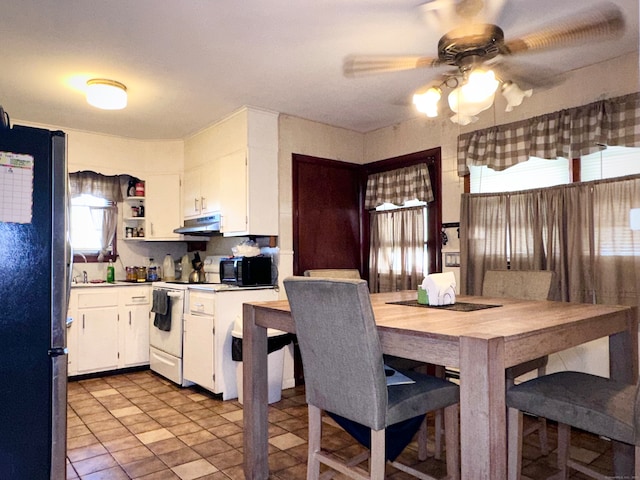 kitchen with white cabinetry, sink, ceiling fan, stainless steel fridge, and white stove