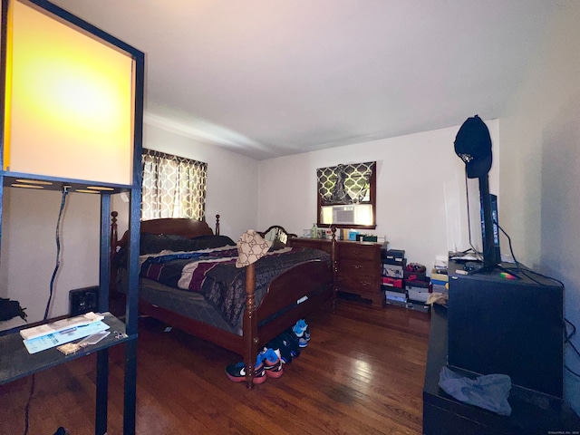 bedroom featuring cooling unit and dark hardwood / wood-style floors