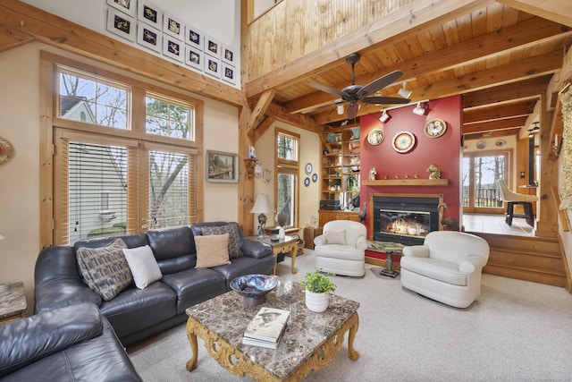 living room with carpet flooring, wooden ceiling, ceiling fan, and beamed ceiling