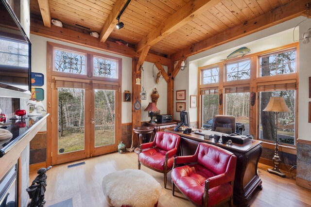 home office with light hardwood / wood-style floors, beam ceiling, wood ceiling, and french doors