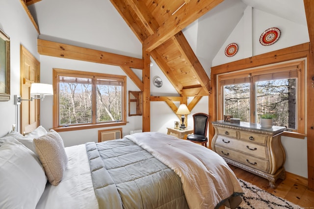 bedroom with light wood-type flooring and lofted ceiling with beams