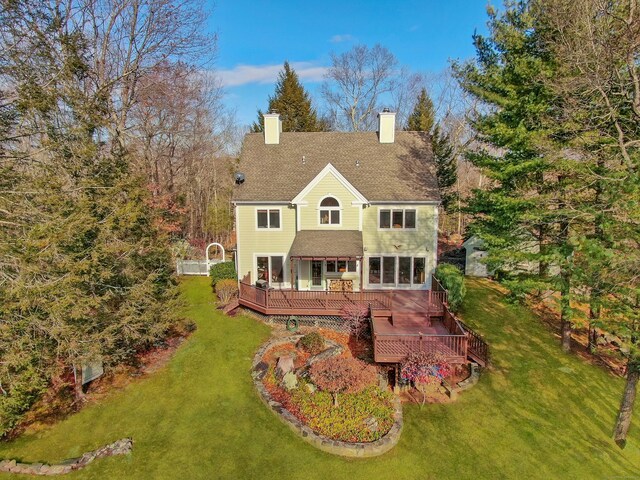 back of house with a yard and a wooden deck