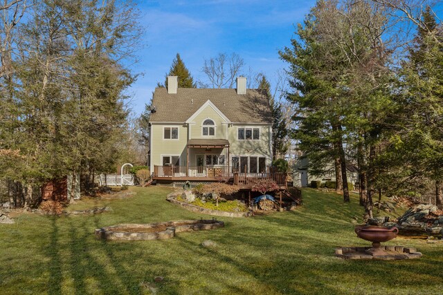 back of house featuring a yard and a deck