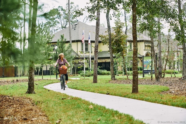 surrounding community featuring a yard and fence