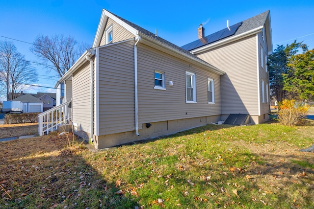 view of side of property with a yard