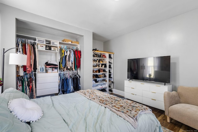 bedroom featuring dark hardwood / wood-style floors and a closet