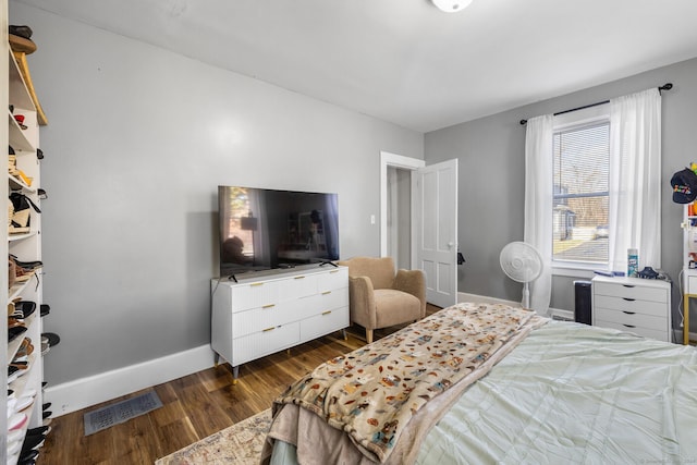 bedroom with dark wood-type flooring