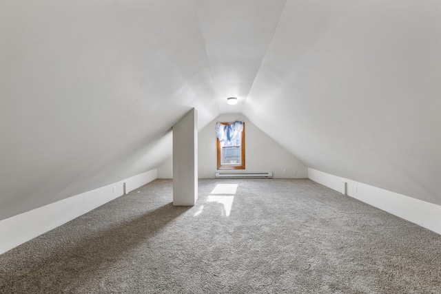 additional living space with carpet flooring, a baseboard radiator, and vaulted ceiling