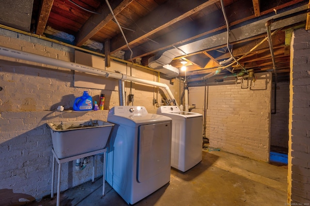 laundry room with washing machine and dryer and sink