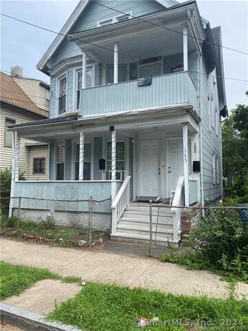 view of front of home with a porch and a balcony