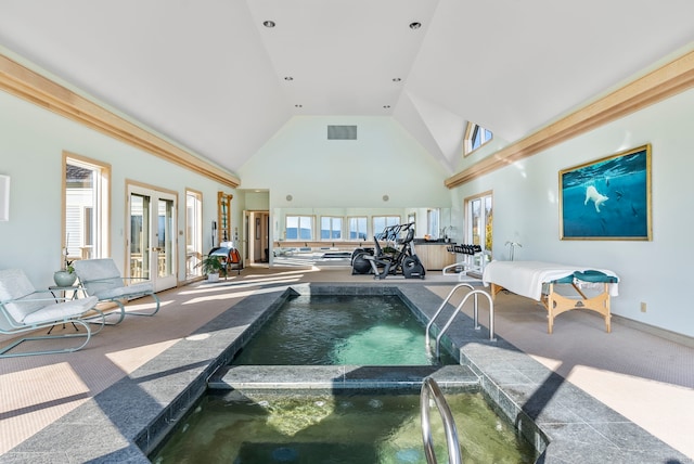 view of pool with french doors and an indoor hot tub