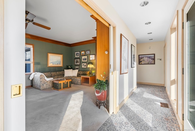 corridor featuring light colored carpet and ornamental molding