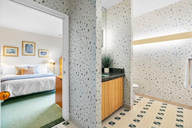 bathroom with tile patterned flooring, vanity, and toilet