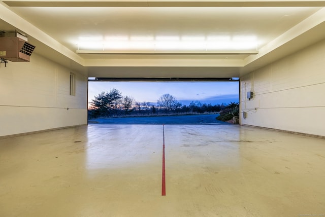 view of garage at dusk