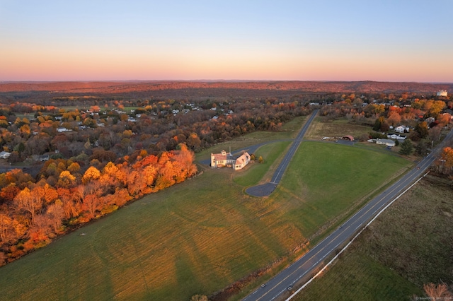 aerial view at dusk featuring a rural view