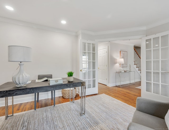 home office featuring hardwood / wood-style flooring, ornamental molding, and french doors