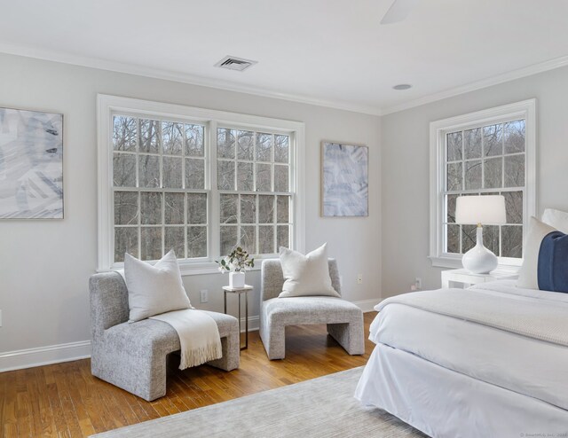 bedroom with hardwood / wood-style floors and crown molding