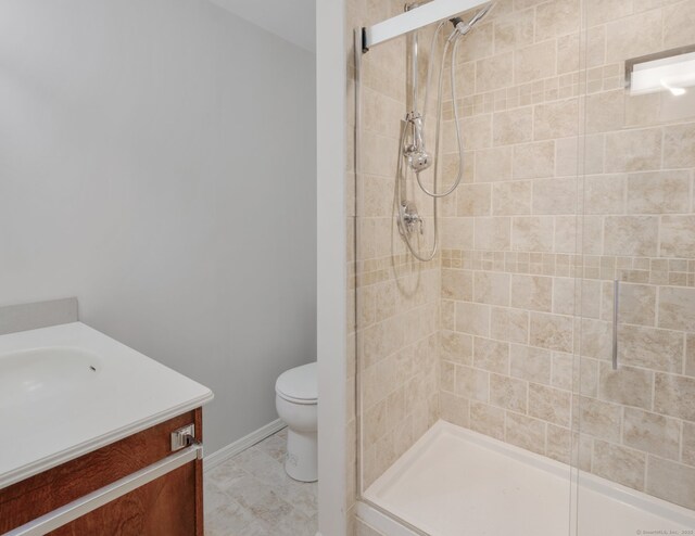 bathroom featuring vanity, toilet, and walk in shower