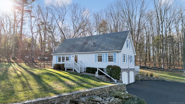 view of front of property with a front yard and a garage