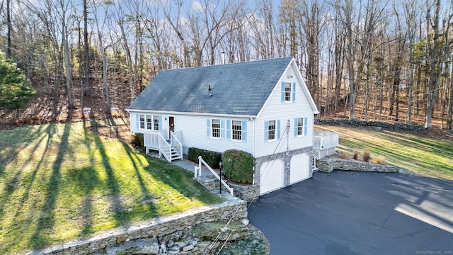 view of front of home with a garage and a front lawn