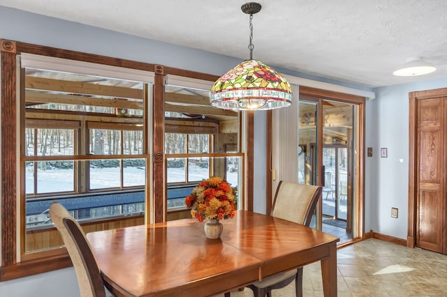 dining space featuring a textured ceiling