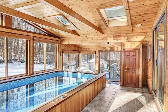 view of swimming pool with an indoor hot tub and a skylight