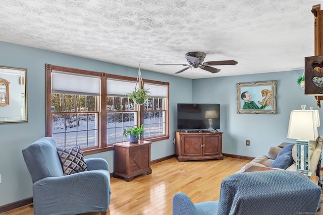 living room with light hardwood / wood-style flooring and ceiling fan