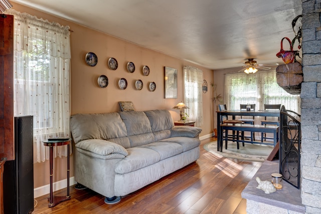 living room featuring ceiling fan and wood-type flooring