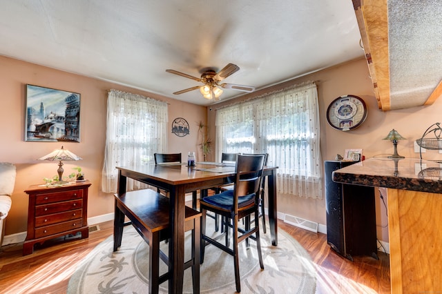 dining area featuring a textured ceiling, hardwood / wood-style flooring, and ceiling fan