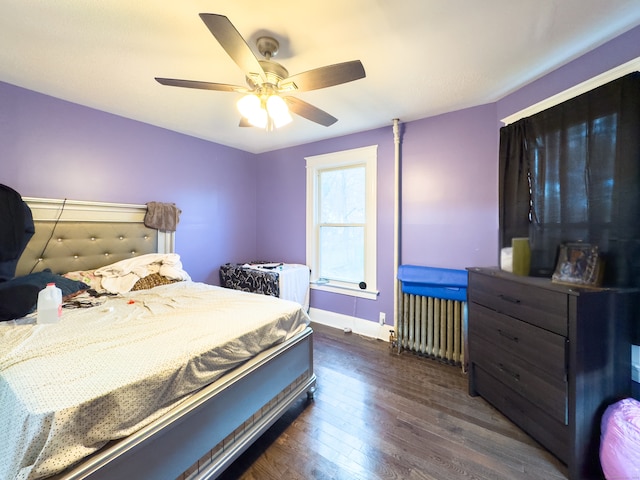 bedroom with ceiling fan, dark hardwood / wood-style flooring, and radiator heating unit