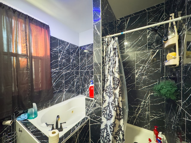 bathroom featuring tile walls and independent shower and bath