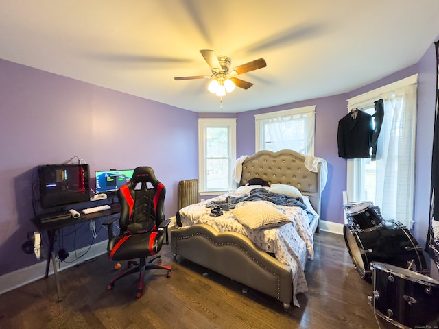 bedroom with dark hardwood / wood-style floors and ceiling fan