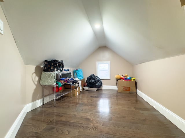 additional living space featuring dark hardwood / wood-style flooring and vaulted ceiling