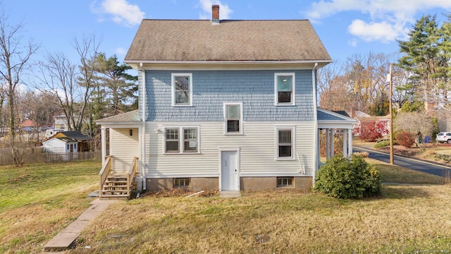 rear view of house with a yard