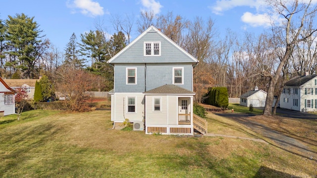 rear view of property with a yard and ac unit