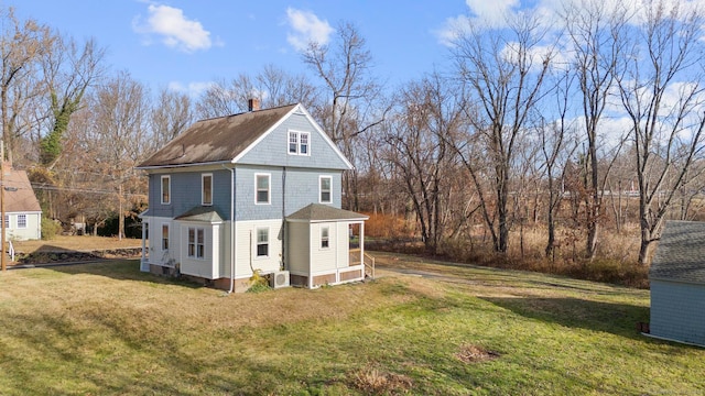 view of side of property with a yard