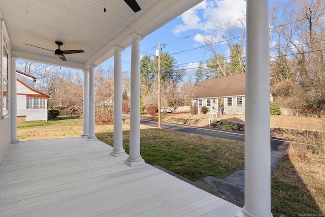 deck featuring ceiling fan and a lawn