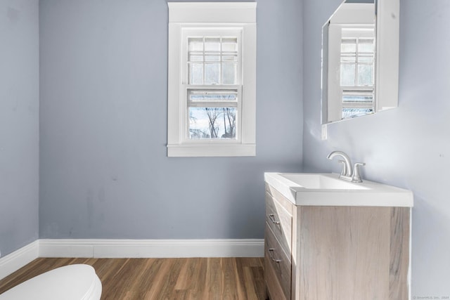 bathroom with vanity, hardwood / wood-style flooring, and toilet