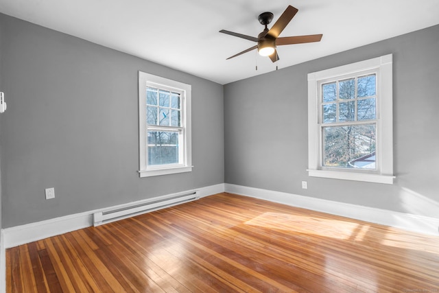 unfurnished room with baseboard heating, ceiling fan, and hardwood / wood-style flooring