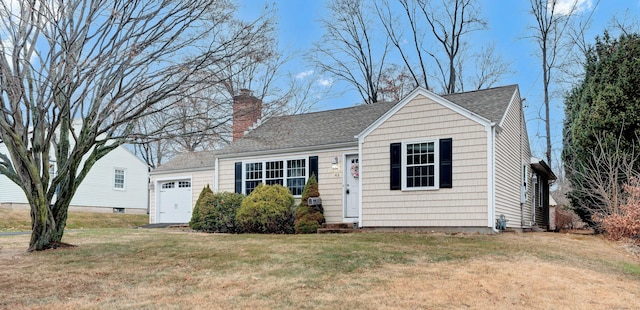 view of front of house with a garage and a front yard