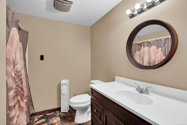 bathroom with tile patterned floors, vanity, and toilet