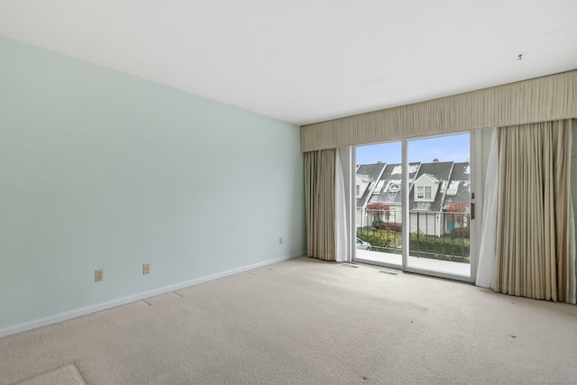 spare room with light colored carpet