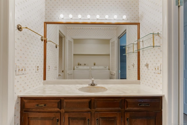 bathroom with washer and dryer and vanity