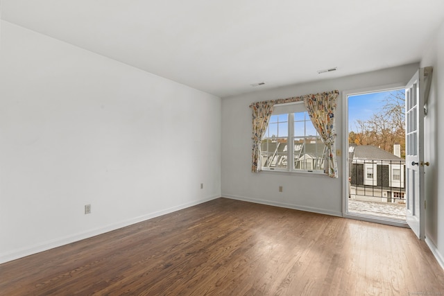 spare room featuring wood-type flooring