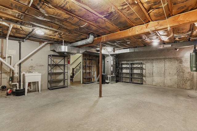 basement featuring heating unit and sink