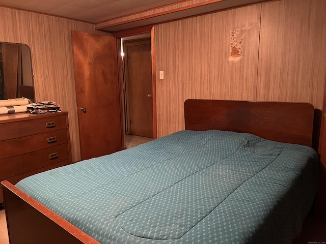 bedroom featuring wood walls