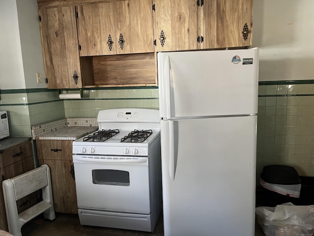 kitchen with white appliances and decorative backsplash